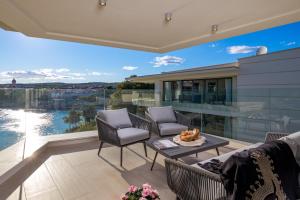 a patio with a view of the water at HADRIE LUXURY RESORT AND VILLAS Krk in Krk