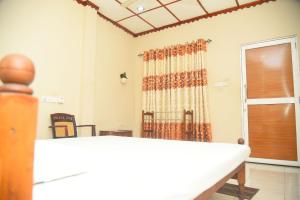 Ένα ή περισσότερα κρεβάτια σε δωμάτιο στο Hotel Prasanna