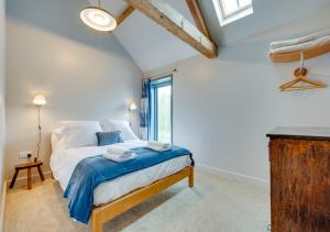 a bedroom with a bed in a room with a window at The Granary at The Foldyard in Holme upon Spalding Moor
