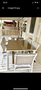 a patio with a table and chairs on a porch at Mobile Home Pinija in Jezera