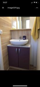 a bathroom with a white sink and a counter at Mobile Home Pinija in Jezera