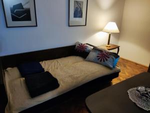 a couch with pillows on it in a living room at Vintage apartment in the center of Novi Sad in Novi Sad