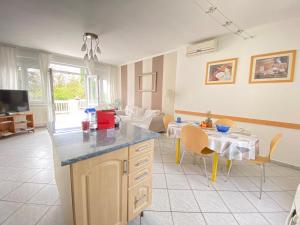 a kitchen and living room with a table and a couch at Dandelion Szépvölgyi Vendégház in Badacsonytomaj +18 photos