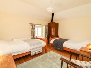 a bedroom with two beds and a window at Myrtle Villa in Knighton