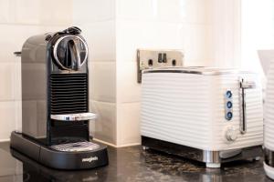 a toaster sitting on a counter in a kitchen at Pier Reflections - seafront apartment in Eastbourne