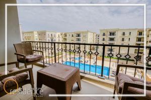 a balcony with a view of a pool and buildings at Luxury apartments in Mivida new cairo in New cairo