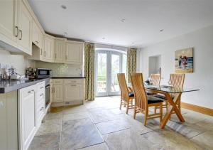 a kitchen with a table and chairs and a dining room at The Cottage in Whitby