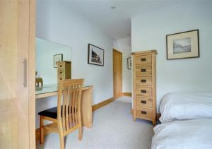 a bedroom with a desk and a bed and a desk at The Cottage in Whitby
