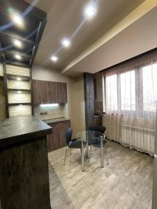 a meeting room with a table and chairs and a counter at Avchieva's apartment on Orbeli Brothers Street in Yerevan