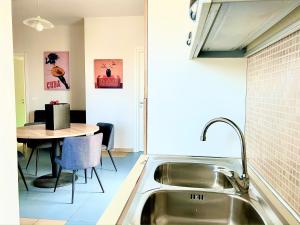 a kitchen with a sink and a table at Suite Petrelli in Torre dell'Orso