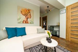 a living room with a white couch and a table at House Rosa in Mali Lošinj