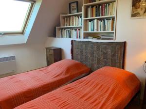 twee bedden naast elkaar in een slaapkamer bij Maison face l’Ocean in Plozévet