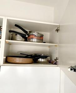a kitchen with some pots and pans on a shelf at Kleine Wohnung im Zentrum Bern nähe Marzili in Bern