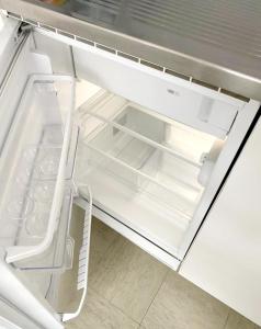 a refrigerator with its door open with a drawer at Kleine Wohnung im Zentrum Bern nähe Marzili in Bern