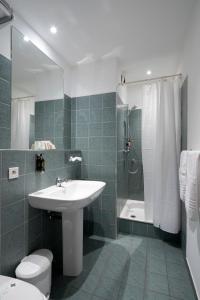 a bathroom with a sink and a shower and a toilet at Excelsior in Saint-Raphaël