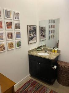 a bathroom with a sink and a mirror at Elegant Downtown Memphis Loft - Walk to Beale St! in Memphis