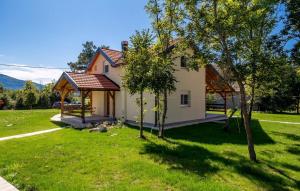a small white house with a gazebo in a yard at Casa Verde and Casa Blue in Janja Gora