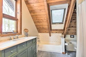 a bathroom with a tub and a sink and a bath tub at Waitsfield Vacation Rental with Private Hot Tub in Waitsfield +16 photos