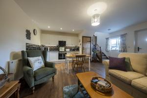 a living room with a couch and chairs and a table at The Hoglets 3 in Goostrey