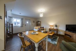 a living room with a table and a couch at The Hoglets 3 in Goostrey