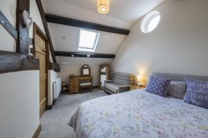 a bedroom with a king sized bed and a chair at The Hoglets 3 in Goostrey