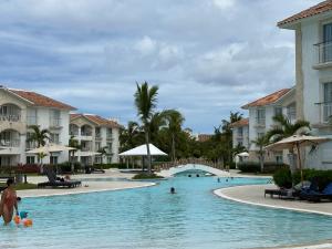 ein Pool in einem Resort mit Menschen im Wasser in der Unterkunft Hotel Palmera Bayahibe in Bayahibe