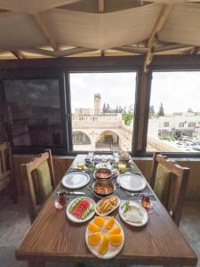 a wooden table with plates of food on it at PALMYRA BOUTIQUE HOTEL in Urfa