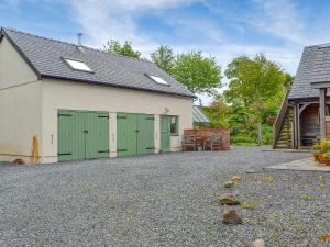 a garage with green doors on a house at Field View in Cynghordy