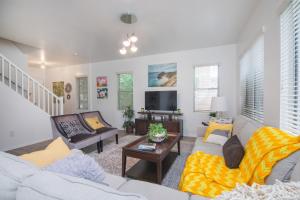 a living room with two couches and a tv at Stylish Home Phoenix - Low Rates NOW! in Phoenix