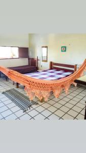a large table in a room with two benches at casa de praia a beira mar in Campina