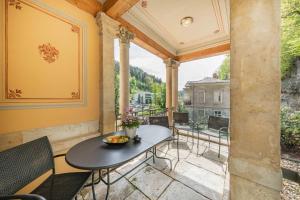 a patio with a table and chairs on a balcony at Villa Emma in Bad Schandau