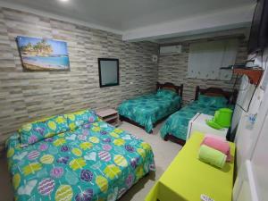 uma sala de estar com duas camas e um sofá em Jackson House Inn em San Andrés