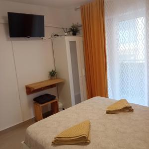a bedroom with a bed and a window with a television at Sweet dreams in Alicante