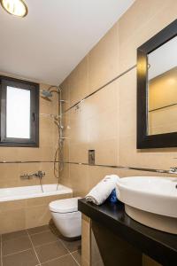 a bathroom with a sink and a toilet and a tub at Ira Gennadi Rhodes in Gennadi
