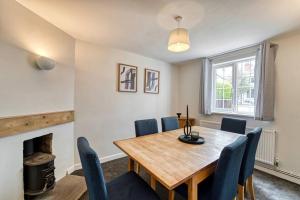 a dining room with a table and chairs and a fireplace at Guest Homes - Birches Barn in Wolverhampton