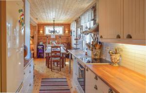 a kitchen with a table and a dining room at Awesome Home In Leira I Valdres With Kitchen in Leira