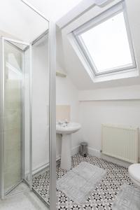 a bathroom with a shower and a sink at Victoria Parade in Rossendale