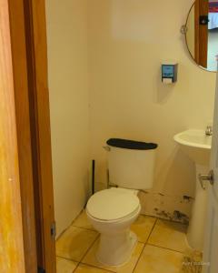 a bathroom with a toilet and a sink at Cabañas Antay, antes Casa Kirckir in San Pedro de Atacama