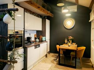 Grisia 26 Apartment في روفينج: مطبخ مع طاولة وطاولة وكراسي صغيرة