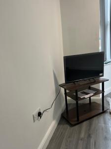 a flat screen tv sitting on a table in a room at Burleigh House - 3 Bed House in Leicester