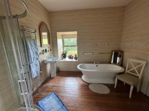 baño grande con bañera y lavamanos en Riverside converted Linen Mill, en Coleraine