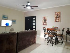 a living room with a couch and a table at Choose To Be Happy at Brompton Estates - One and Two Bedroom with Pool in Kingston