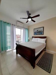 1 dormitorio con 1 cama y ventilador de techo en Choose To Be Happy at Brompton Estates - One and Two Bedroom with Pool en Kingston