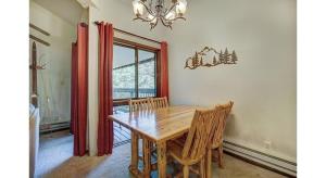 a dining room with a wooden table and chairs at Updated 2Br Plus Loft Condo on Shuttle Route! Sleeps 8 & Kids Ski Free condo in Montezuma