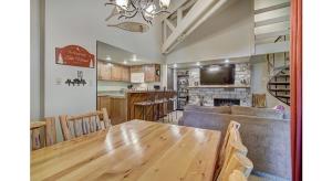 a kitchen and dining room with a table and a couch at Updated 2Br Plus Loft Condo on Shuttle Route! Sleeps 8 & Kids Ski Free condo in Montezuma