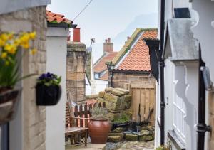 a view of an alley with a bench and buildings at Storm Cottage in Robin Hood's Bay