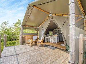 a tent with a table and chairs on a deck at Bluebell - Uk43602 in Llangyniew