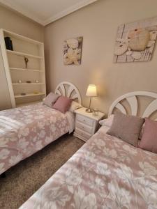 a bedroom with two beds and a night stand at Apartamento constitución in Camargo