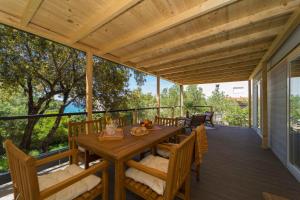 a wooden deck with a wooden table and chairs at Holiday Home Artina 1 in Lovište