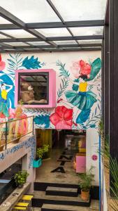a hallway with a mural of flowers on the wall at Hotel Suculenta Boutique in San Cristóbal de Las Casas